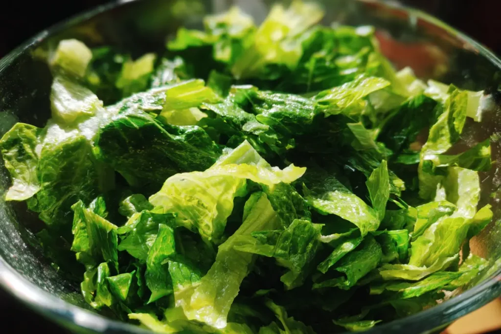 Mediterranean Chopped Salad Made Easy – Fresh, Crunchy, and So Satisfying 25 Finely shredded romaine and spinach in a glass bowl