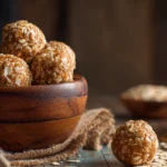 Bowl of no-bake peanut butter oatmeal balls on a rustic kitchen table